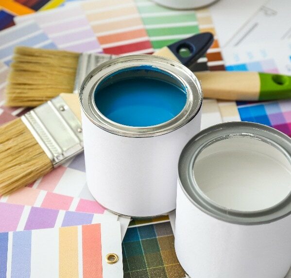 Cans of paint with brushes and palette samples